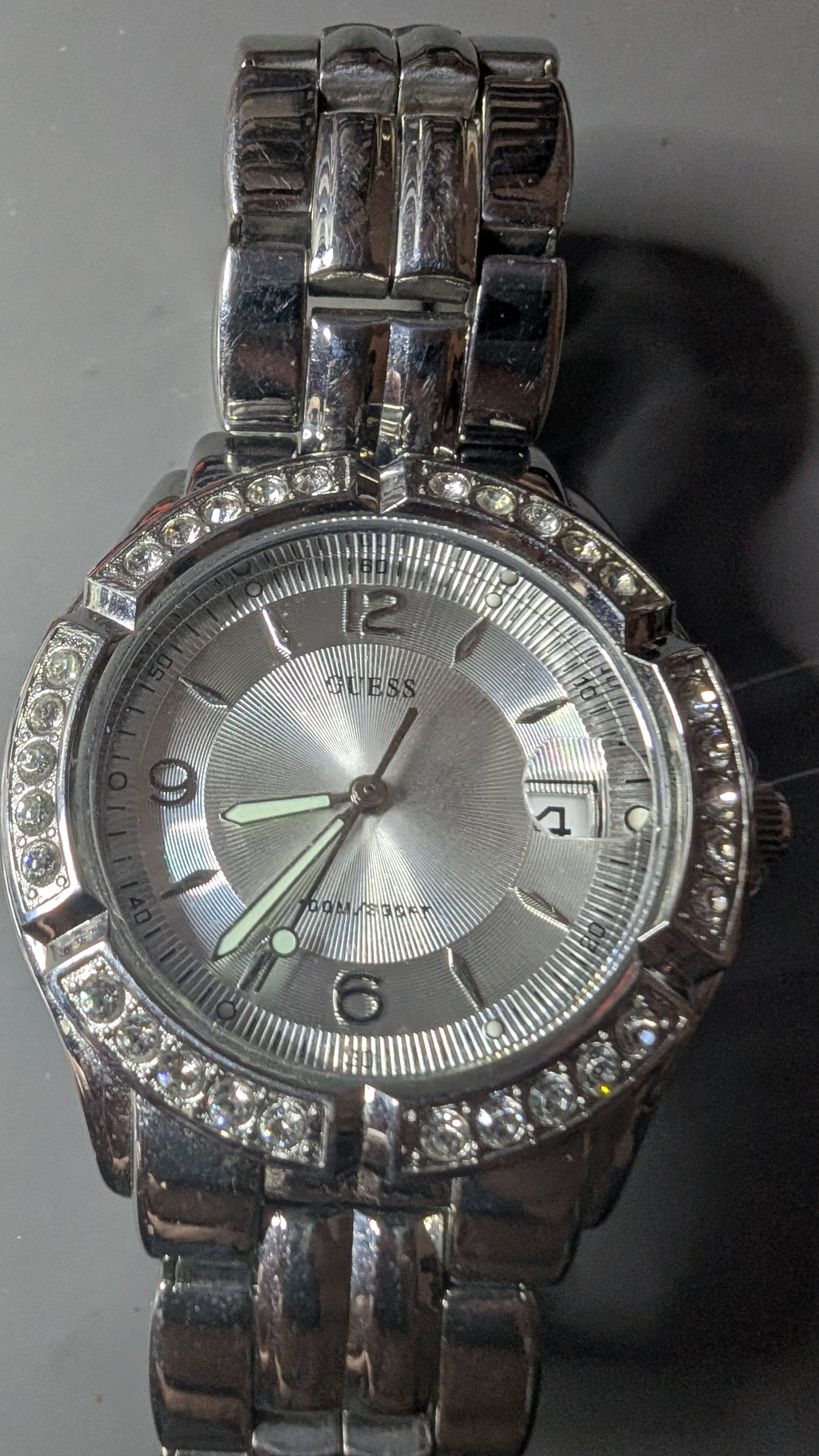 Guess men's sports watch with crystals on the bezel. This is a nice clean watch that keeps good time and has a new battery.