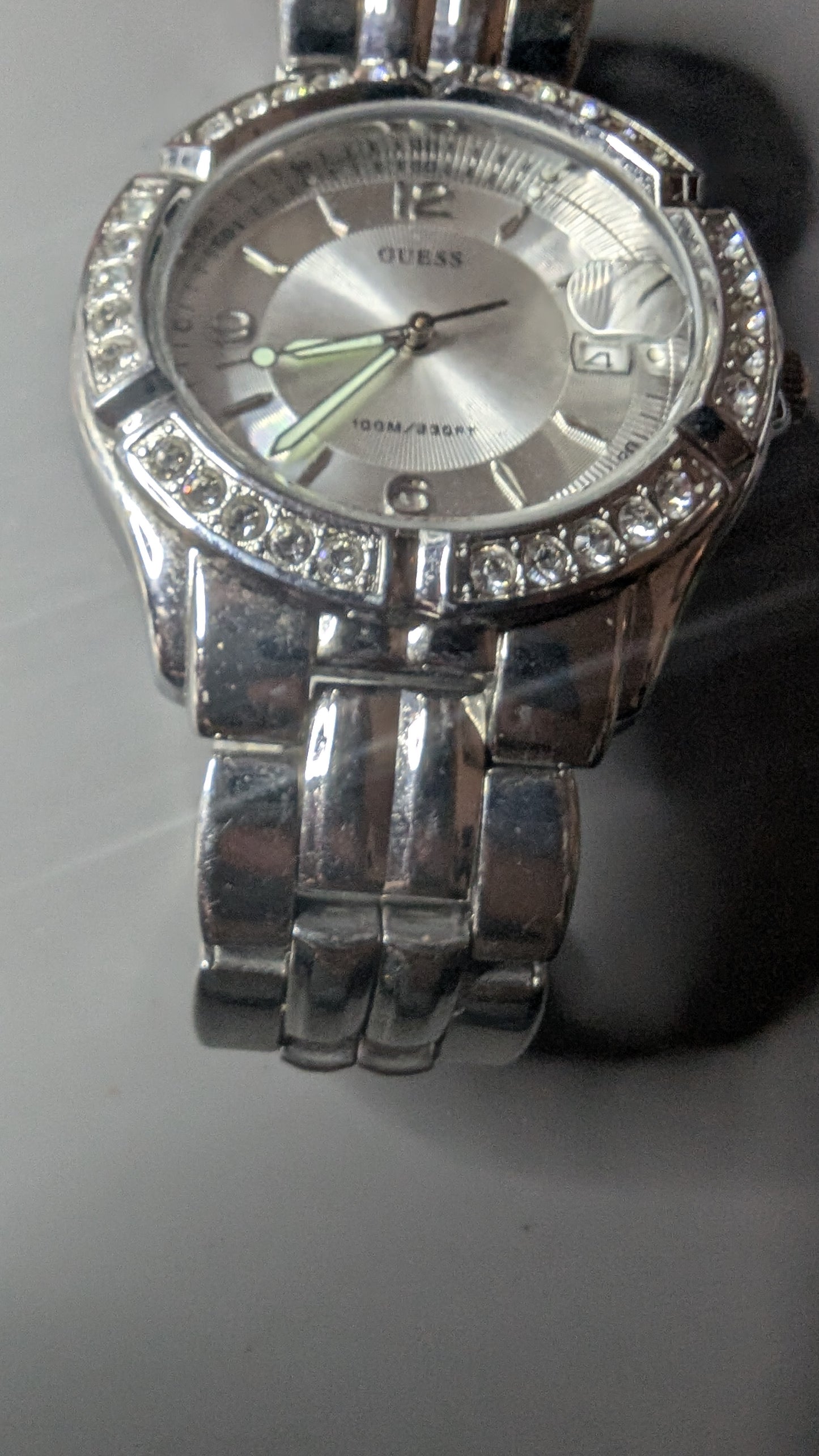 Guess men's sports watch with crystals on the bezel. This is a nice clean watch that keeps good time and has a new battery.