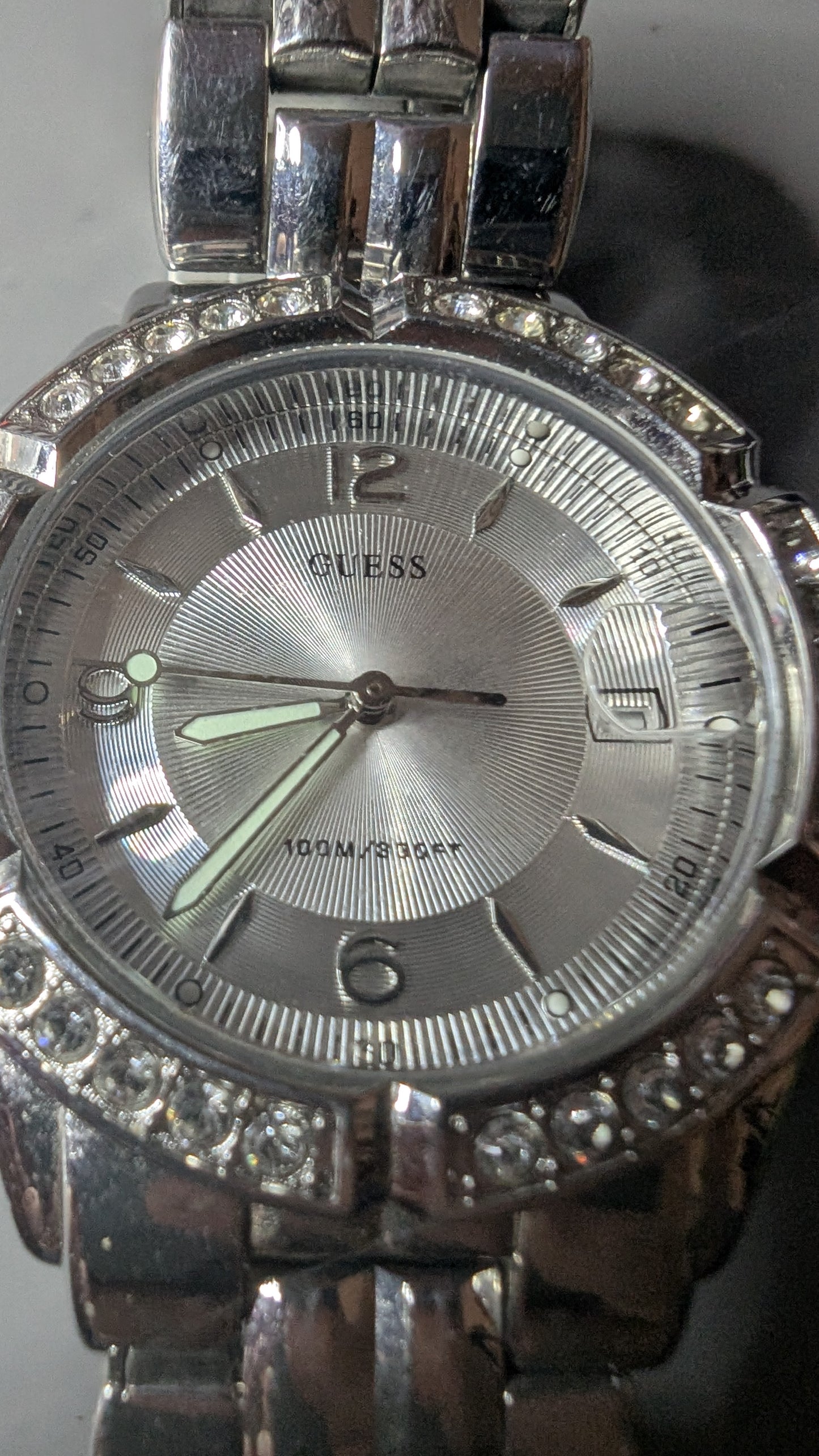 Guess men's sports watch with crystals on the bezel. This is a nice clean watch that keeps good time and has a new battery.