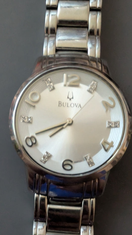 Bulova quartz Diamond watch with new battery and original bracelet band. This is a very beautiful watch that keeps perfect time and is in great condition. Has eight diamonds on dial.